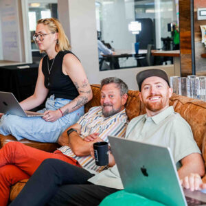 A group of people sitting on a couch in an office