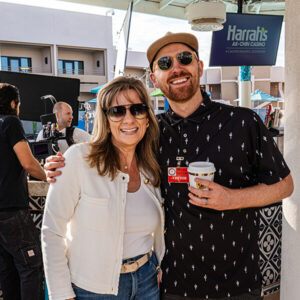 A man and a women hugging a an event outside