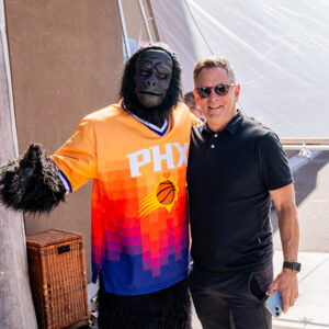 A man and the Suns mascots