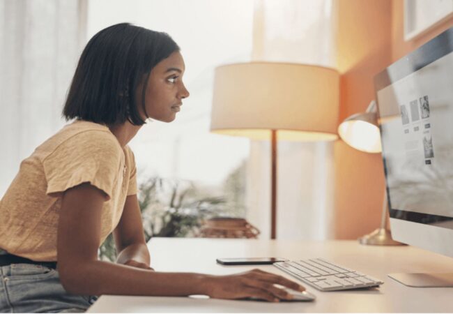 Women sitting at a desk working on the computer