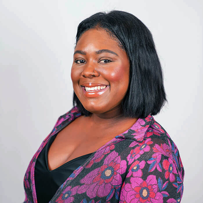 Headshot of a women wearing a floral blazer | Jade Frazier