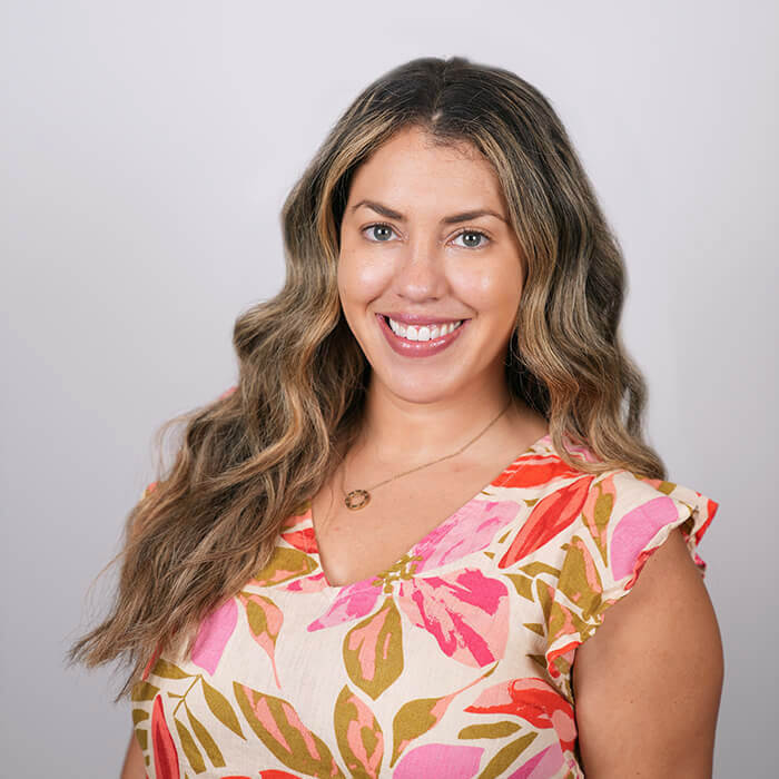 Headshot of women in floral dress | Tai DeAza