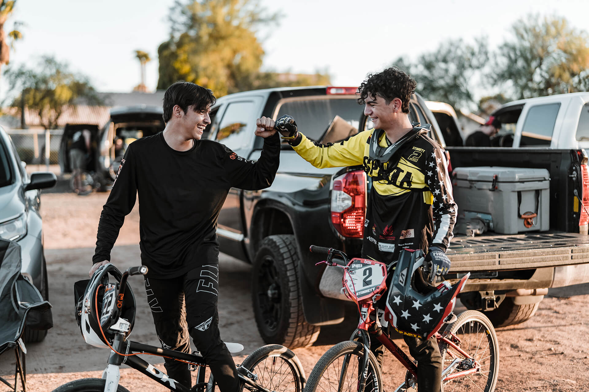 Two BMX riders celebrating