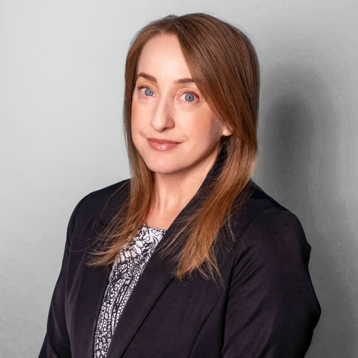Headshot of a women in a black blazer | Janelle Brannock