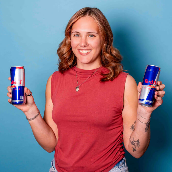 Headshot of a women in a red shirt holding Red Bull | Sophie Hansen