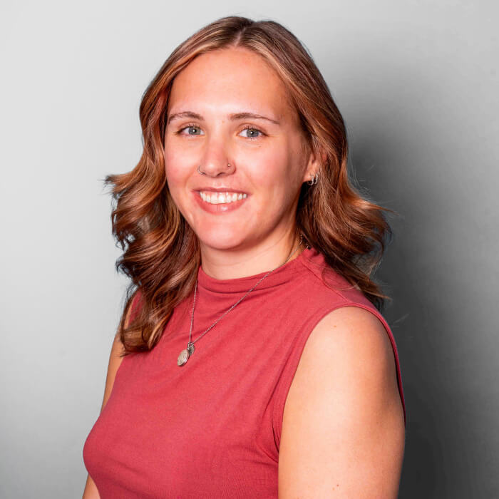 Headshot of a women in a red shirt | Sophie Hansen