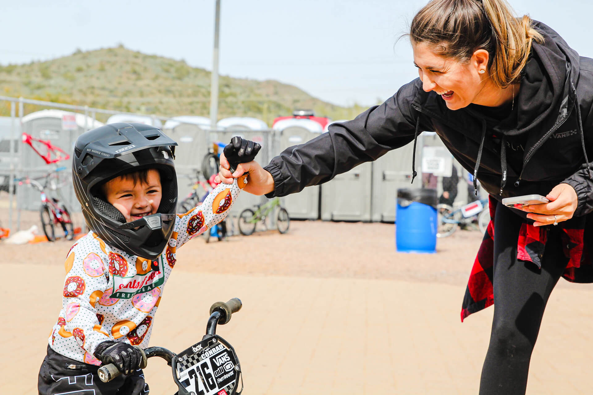 Young BMX rider celebrating with mom