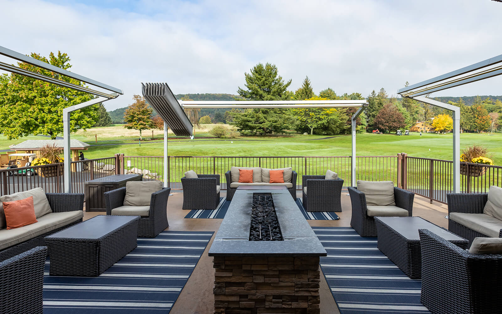 Outdoor furniture on a patio overlooking grass