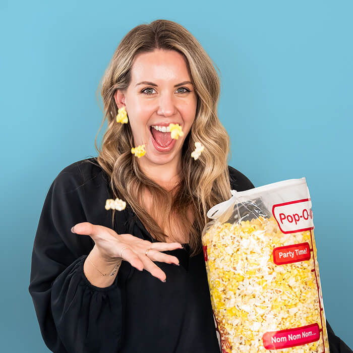 A women tossing up popcorn | Caitlyn Trainor