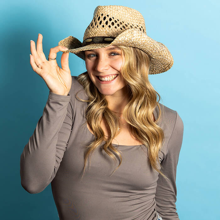 Headshot of a women in a gray top and a cowboy hat