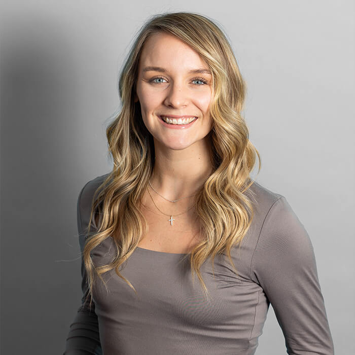 Headshot of a women in women in a gray top