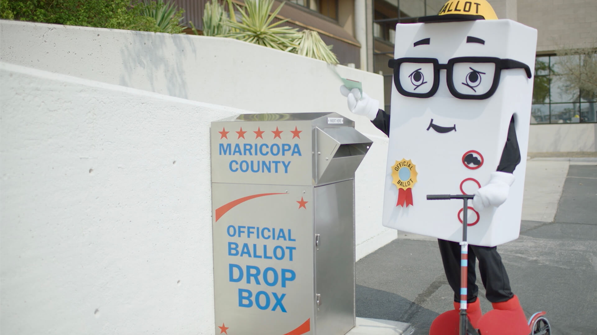 Maricopa County Elections Department mascot by a ballot drop box