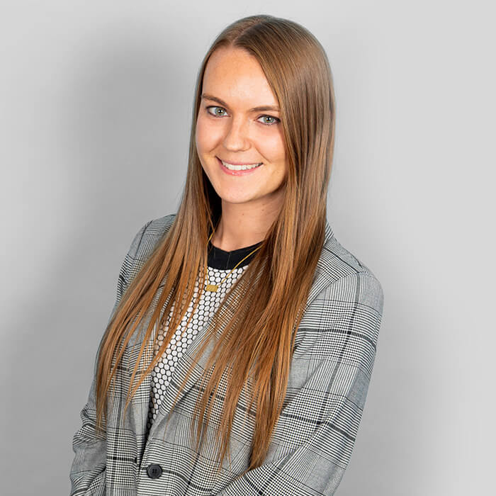 Headshot of a women in a gray blazer