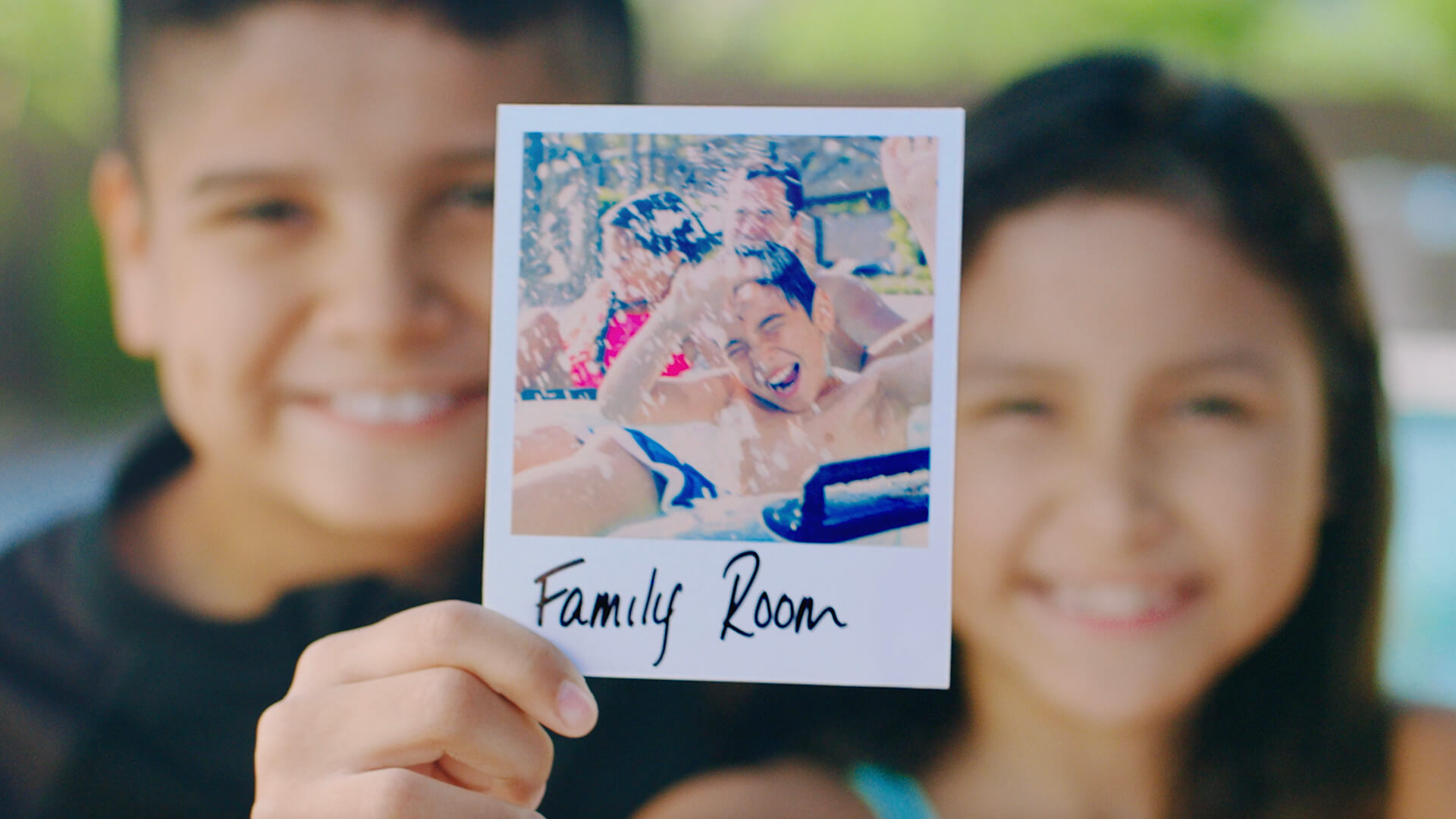 Kids holding a polaroid picture