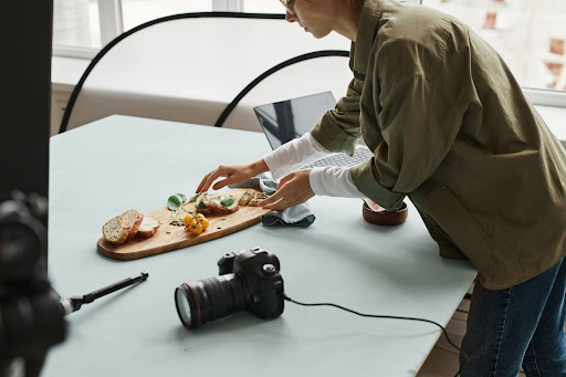 Woman setting up items to photograph them for Product marketing